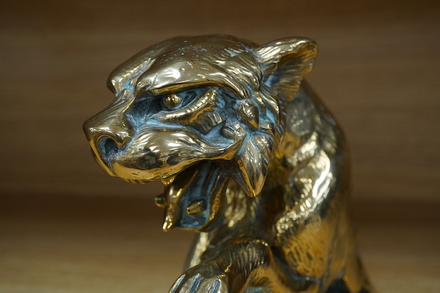 A substantial brass car mascot of the front half of a big cat roaring, mounted on a sheet of brass, 15cm high. Condition - good.